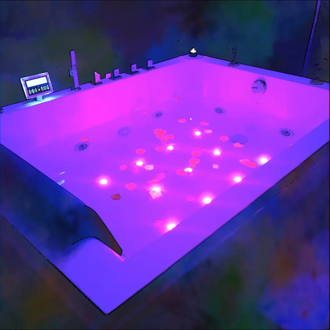 The hot tub lit in violet and pink, jets running under the water